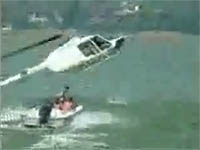 A helicopter attempts to tow a disabled boat