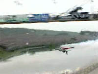 Sukhoi SU-26 flying under a bridge inverted