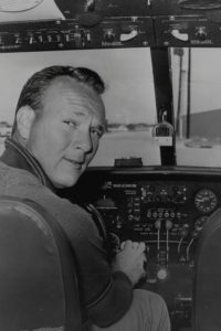 Arnold Palmer at the controls of his Aero Commander twin.